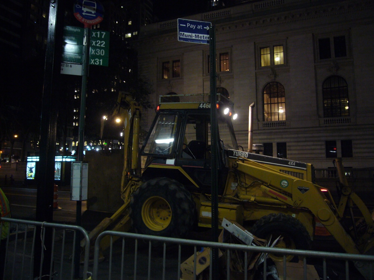 photo of a backhoe at night.